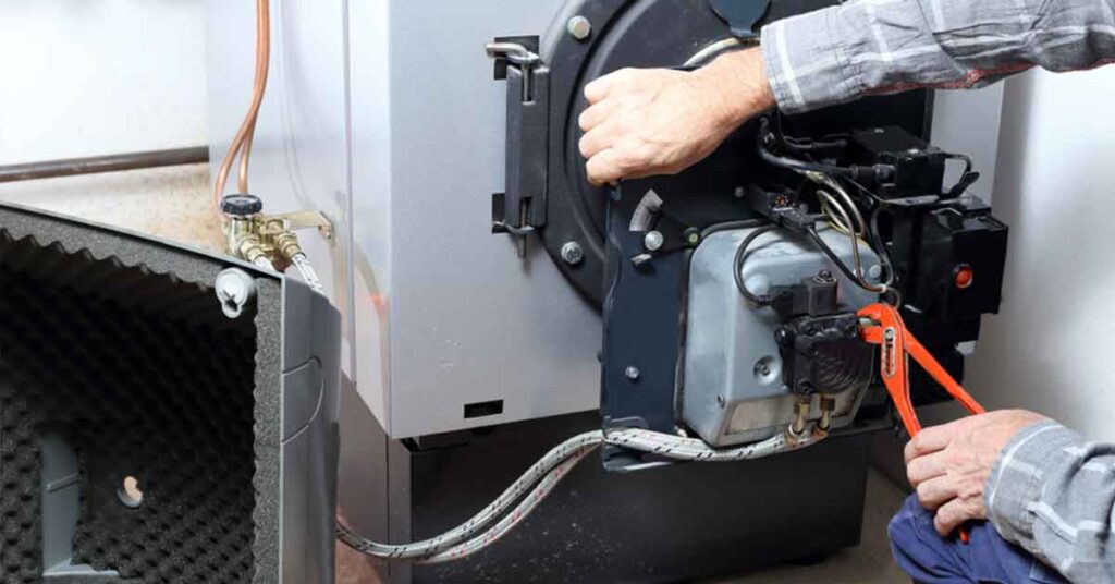 Someone fixing an oil burner