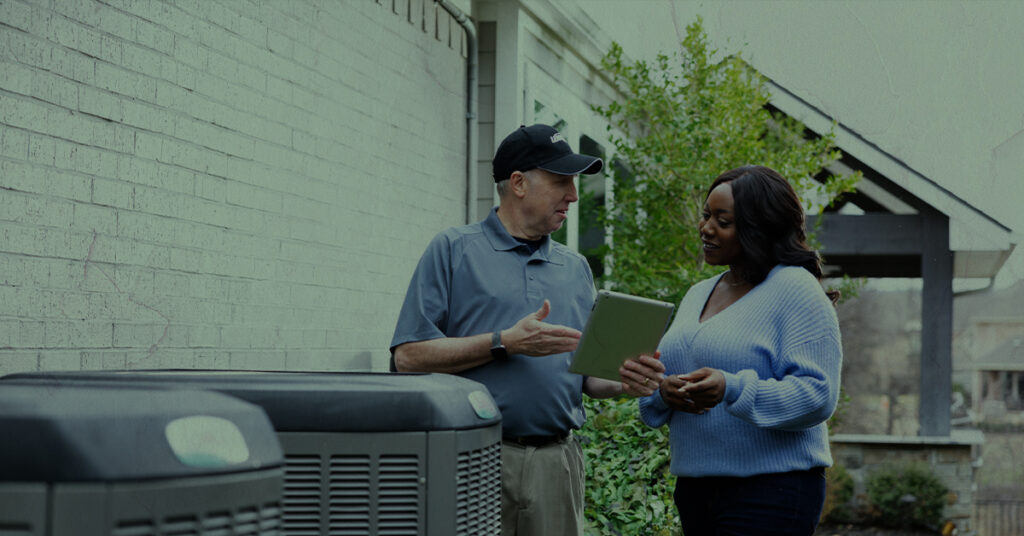 HVAC technician explaining heat pumps and furnaces