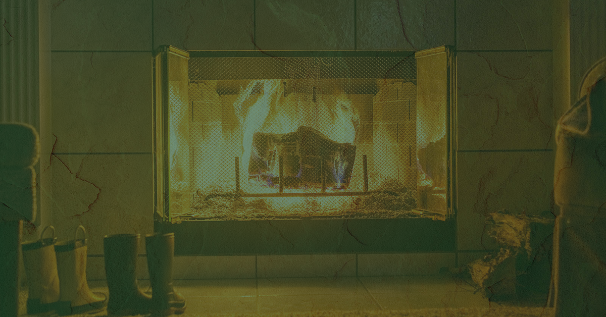Fireplace in the home with boots nearby.